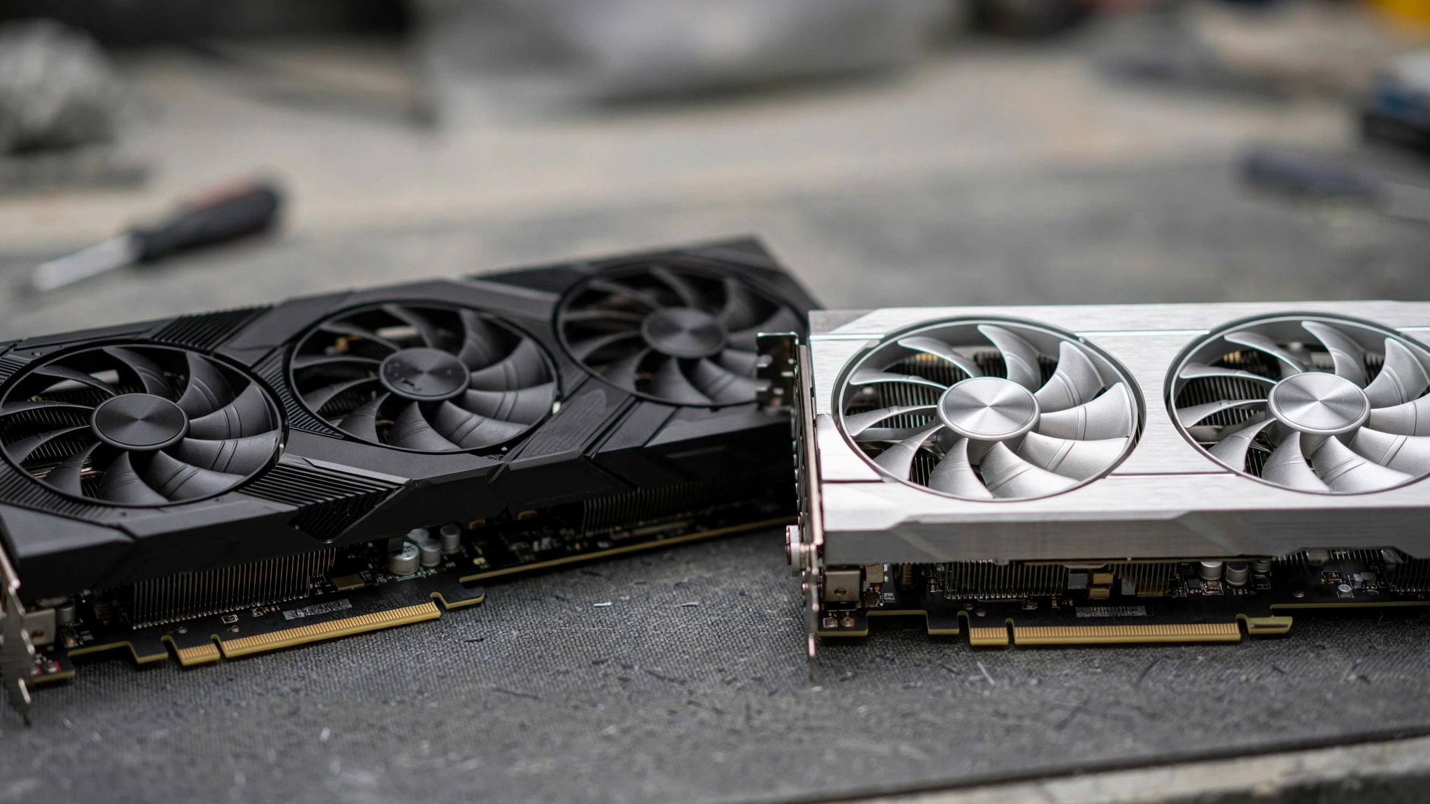 Two graphics cards side by side on a workbench for a 4K GPU comparison
