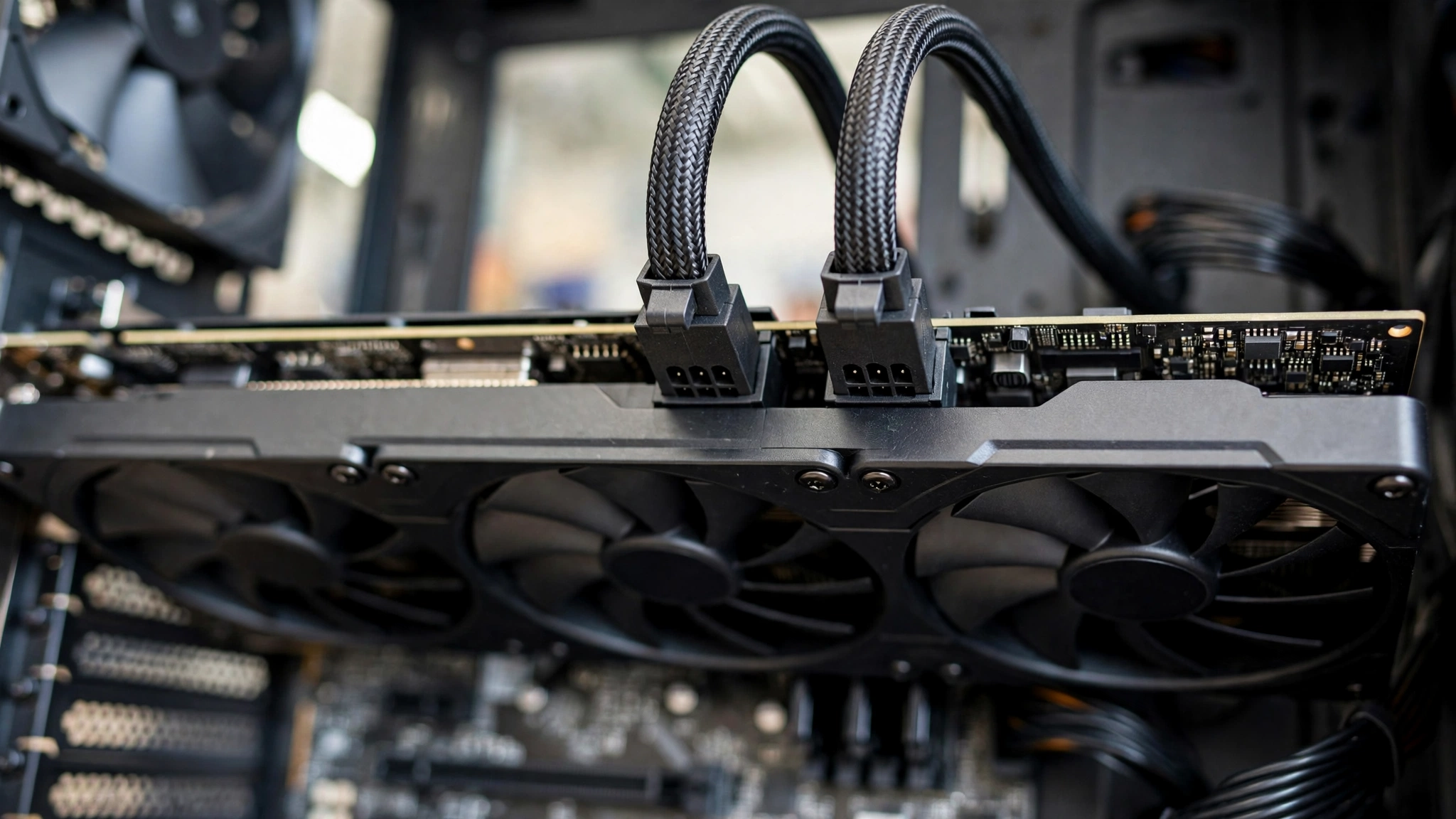Two separate 8-pin PCIe power cables connected to a graphics card for safe RX 9070 XT power delivery